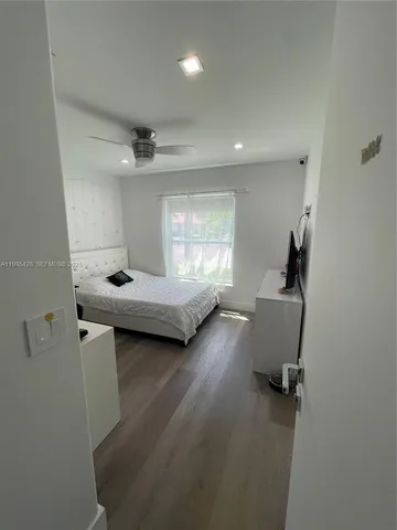 a bathroom with a granite countertop sink mirror vanity and toilet