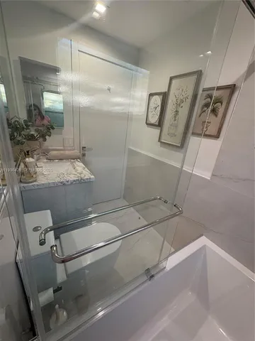 a bathroom with a sink toilet and shower