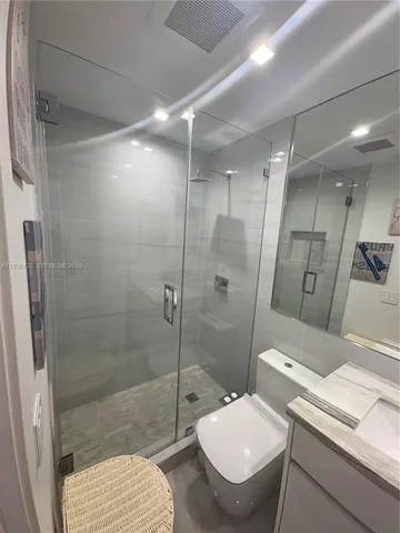 a bedroom with a bed and a mirror