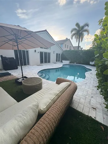 a view of a swimming pool with an outdoor space and seating area