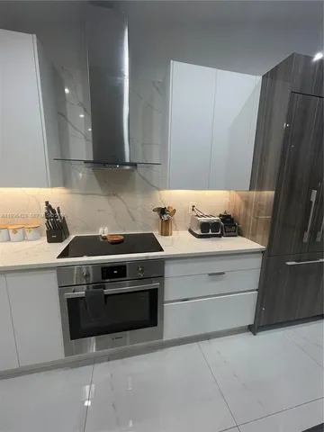 a kitchen with granite countertop a stove and a refrigerator