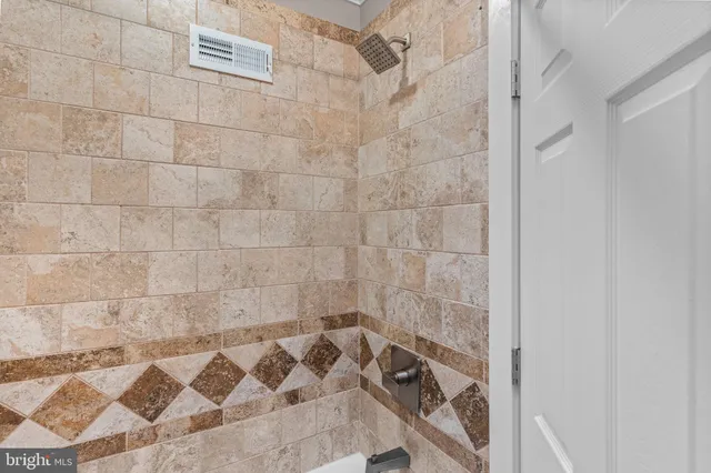 a bathroom with a bathtub and shower