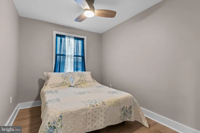 a bed sitting in a bedroom next to a window