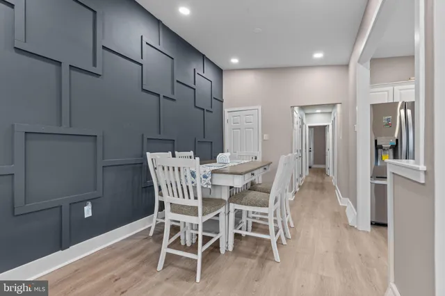 a dining room with furniture and wooden floor