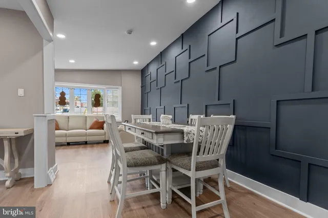 a dining room with furniture and a chandelier