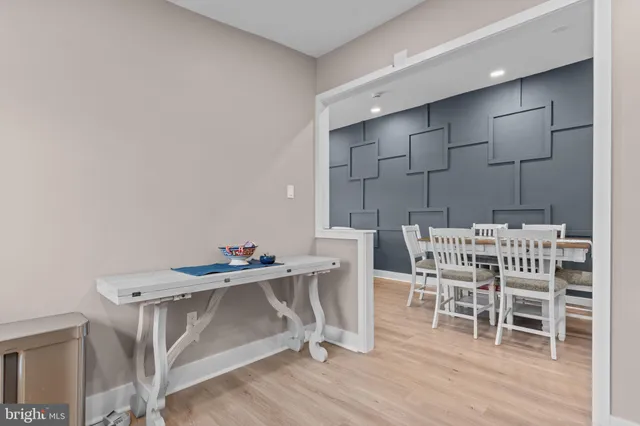 a dining room with furniture wooden floor and a rug