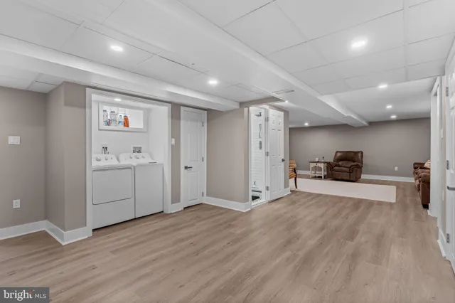 a view of a big room with wooden floor and a sink