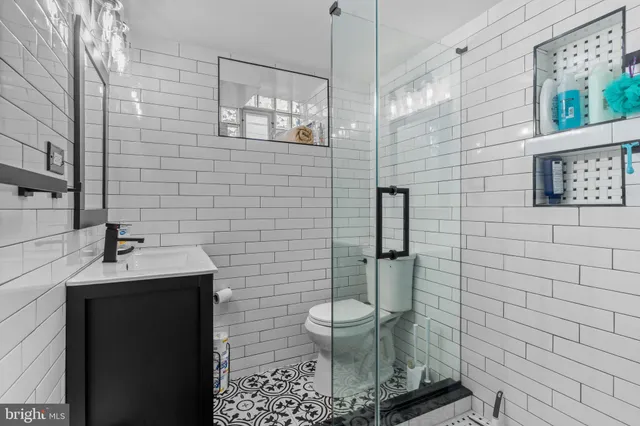 a bathroom with a toilet a sink and mirror