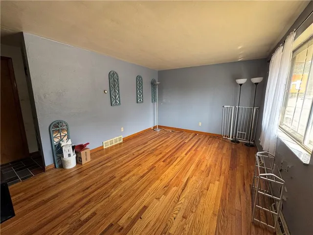 a room with wooden floor and chair