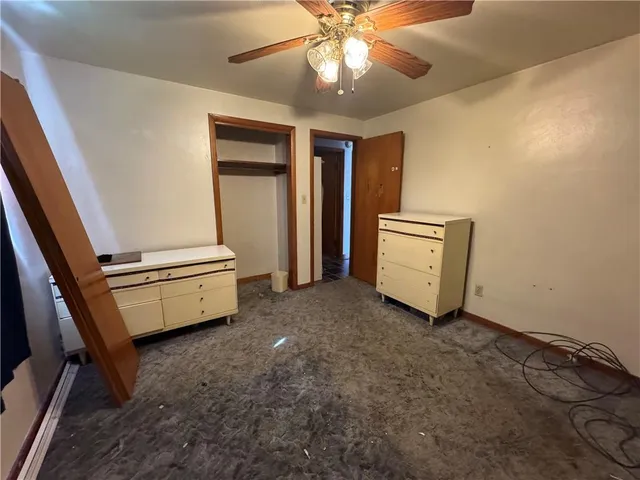 a view of room with stairs and a ceiling fan
