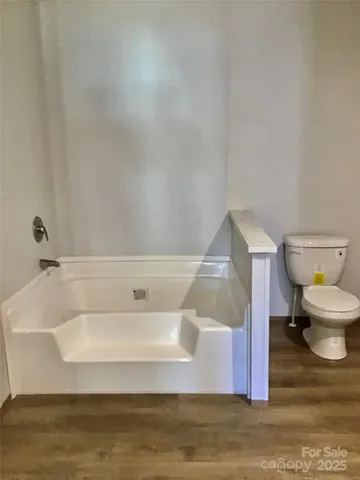 a bathroom with a bathtub and toilet