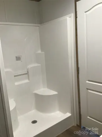 a bathroom with a glass shower door