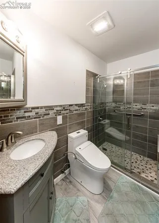 a bathroom with a toilet and a shower