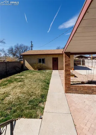 a view of a house with a yard and a garden