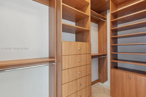 a spacious bathroom with a tub sink and mirror