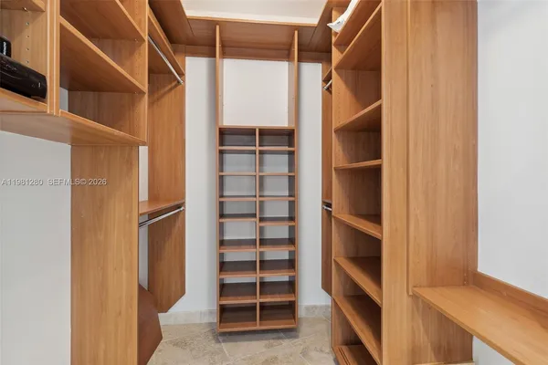 a bedroom with a bed and ceiling fan