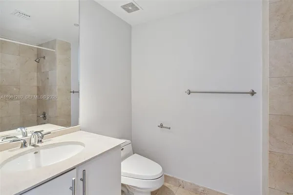 a view of a city with tall buildings and a big yard