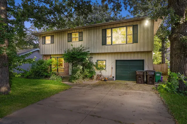 a front view of a house with a garden and yard