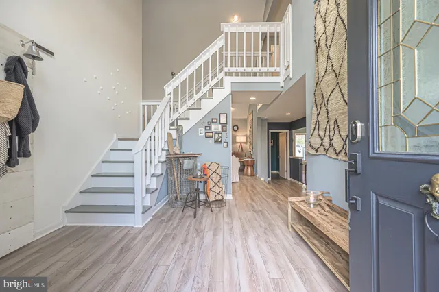 a view of entryway and hall with wooden floor