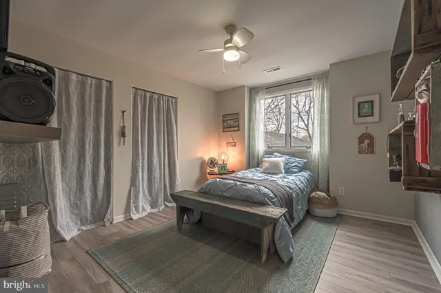 a bedroom with a bed and wooden floor