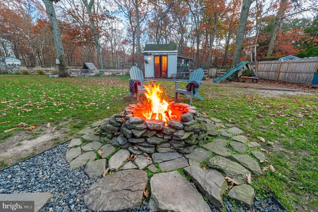 a view of a house with a backyard porch and sitting area