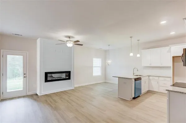 a view of a kitchen with a sink and a refrigerator