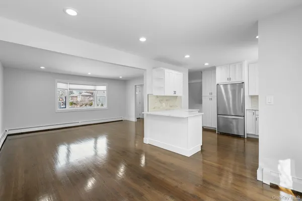 a view of kitchen with cabinets and wooden floor