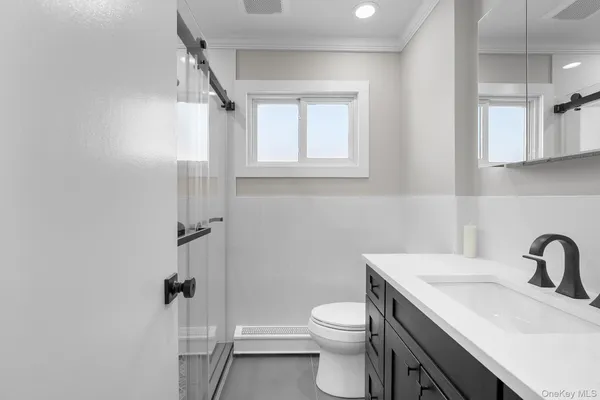 a bathroom with a sink toilet and shower