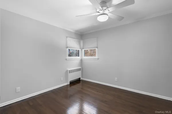 a view of workspace with wooden floor and fan
