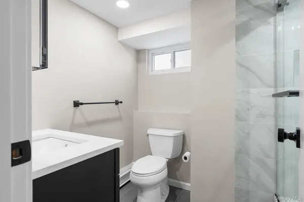 a white toilet sitting next to a bathroom sink