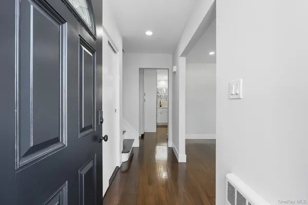 a view of a hallway with wooden floor