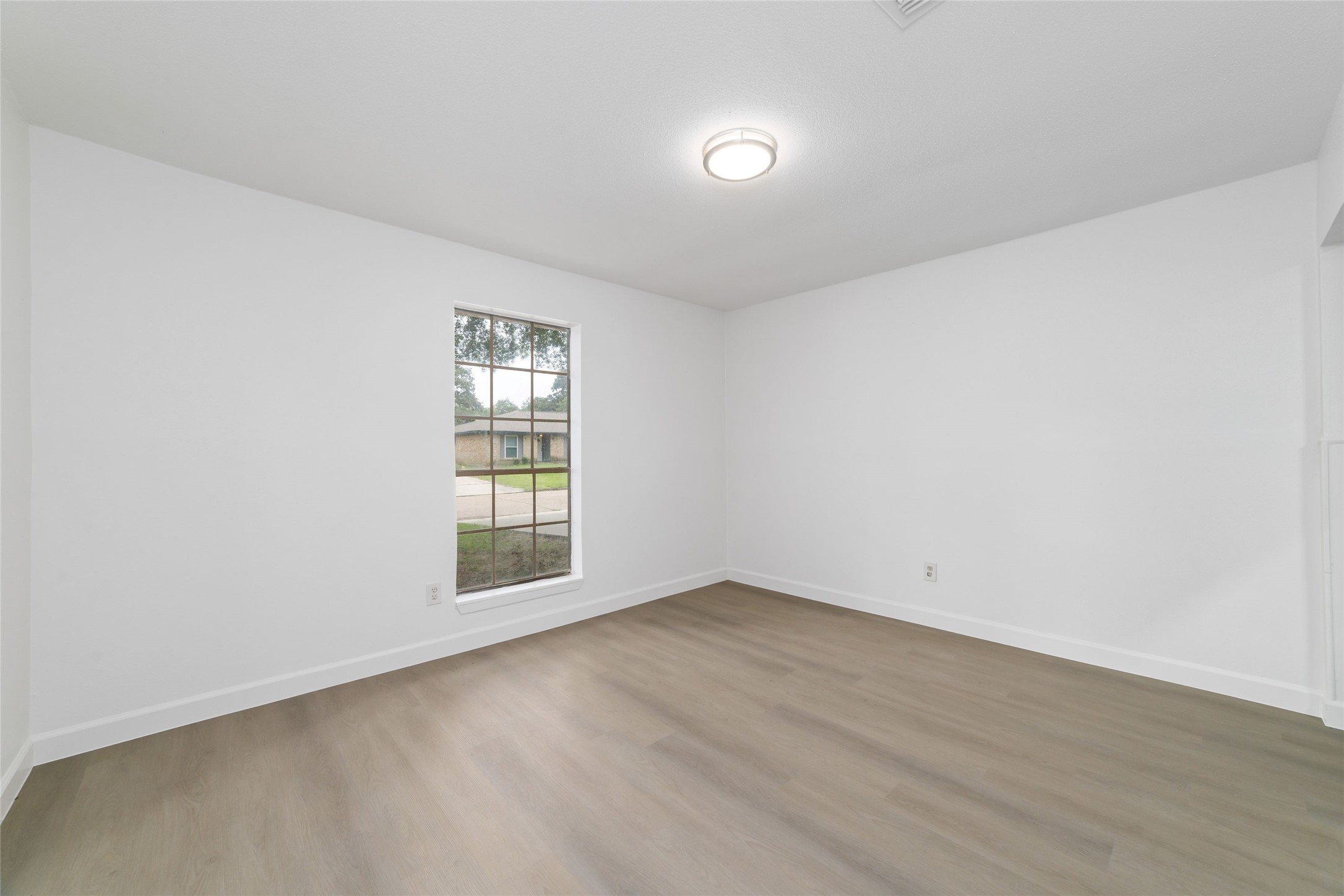 5023 Monteith Drive Spring, TX 77373 - Photo 4 of 20 Bright and airy room with a large window that fills the space with natural light, creating a clean and welcoming feel.