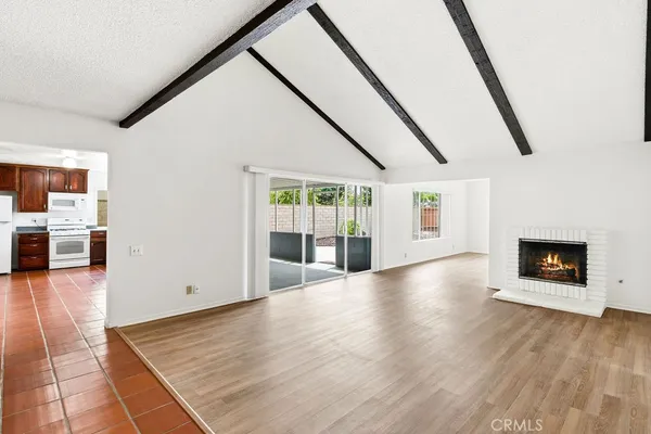 wooden floor in an empty room with a fireplace