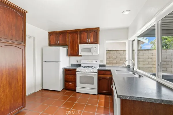 a kitchen with a stove a refrigerator and a sink