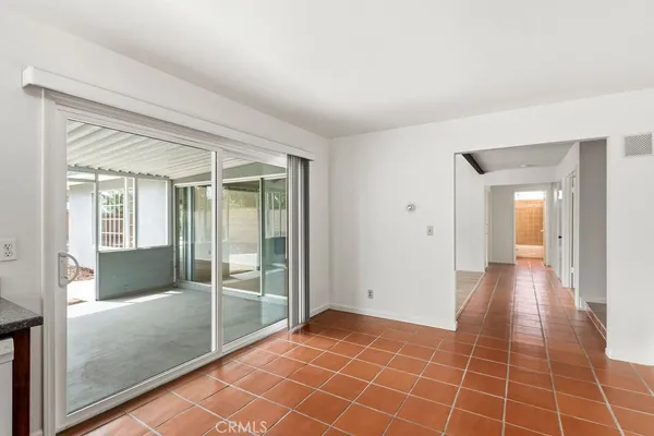 a view of an empty room and glass door