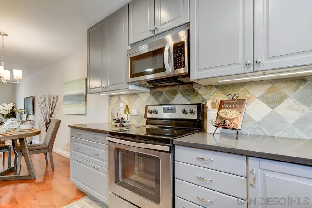 1750 Charleston Lane Encinitas, CA 92024 - Photo 11 of 25 a kitchen with stainless steel appliances granite countertop a stove microwave and cabinets