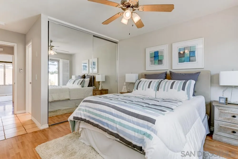 1750 Charleston Lane Encinitas, CA 92024 - Photo 13 of 25 a spacious bedroom with a bed and a chandelier