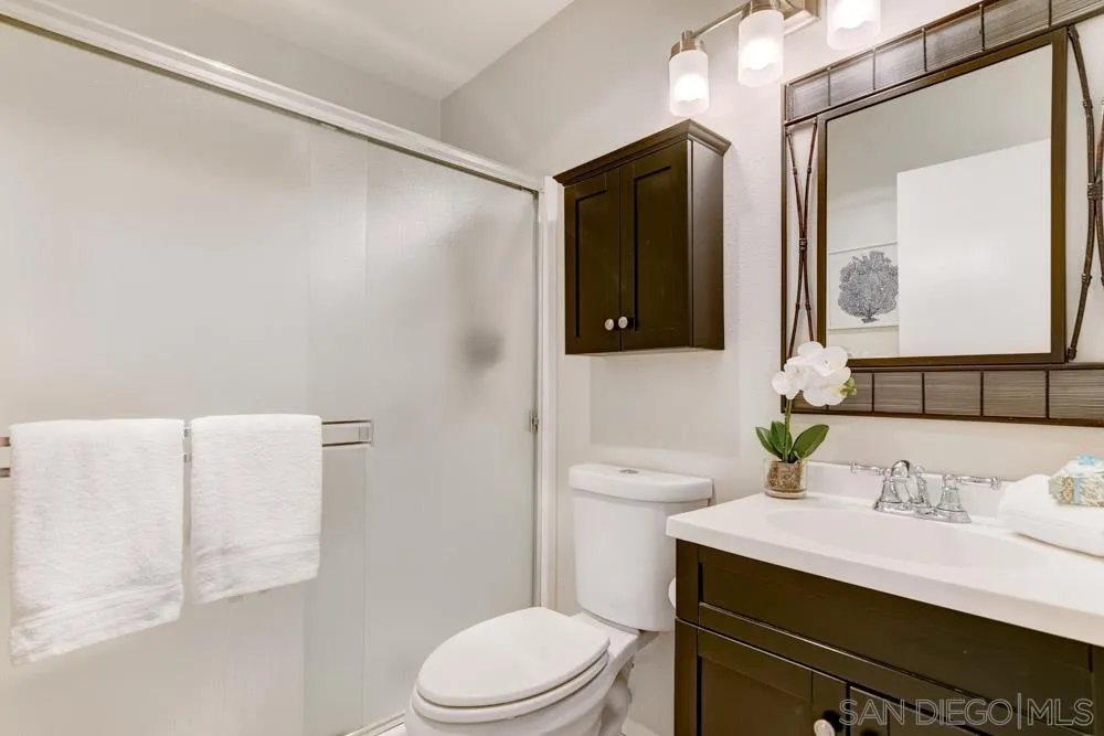 1750 Charleston Lane Encinitas, CA 92024 - Photo 17 of 25 a bathroom with a sink vanity mirror and toilet