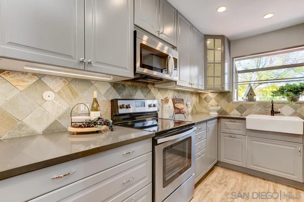 1750 Charleston Lane Encinitas, CA 92024 - Photo 9 of 25 a kitchen with stainless steel appliances granite countertop a sink a stove and cabinets