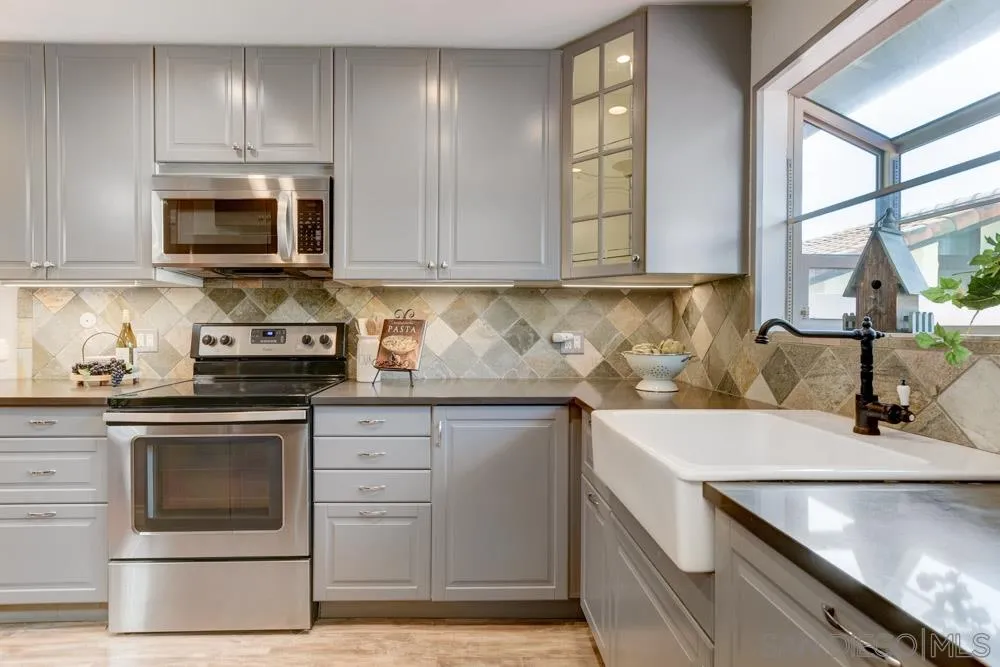 1750 Charleston Lane Encinitas, CA 92024 - Photo 10 of 25 a kitchen with stainless steel appliances granite countertop a sink stove and microwave