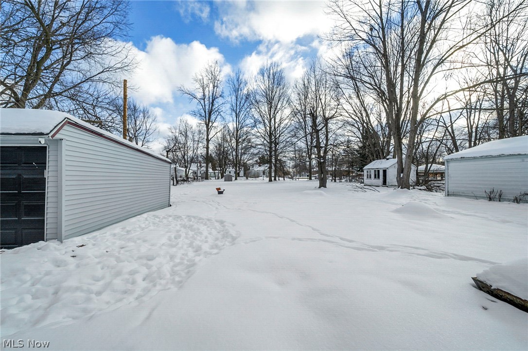 4717 Snow Road Cleveland, OH 44134 - Photo 20 of 30 Snowy yard featuring an outdoor structure