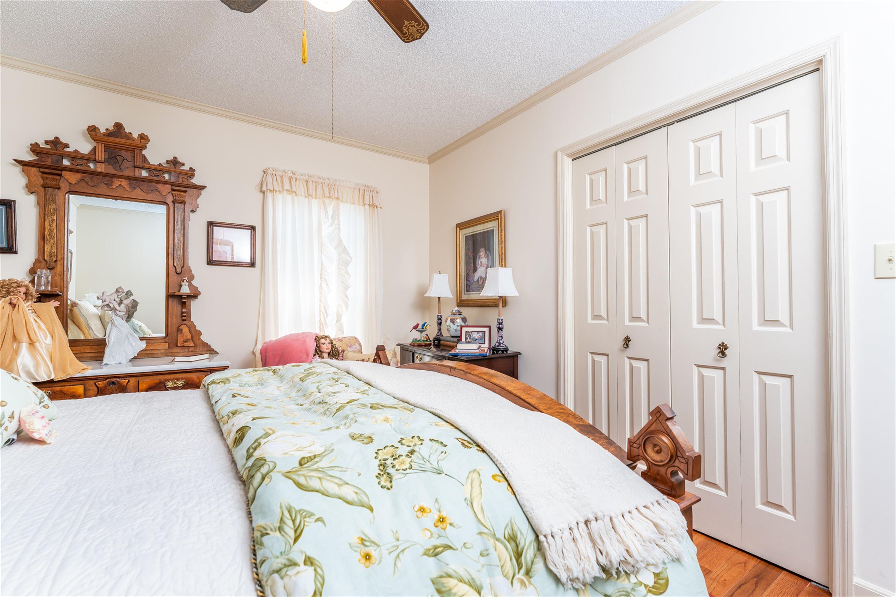 1946 Wood Valley Road Macon, GA 31211 - Photo 22 of 35 a spacious bedroom with a bed and a chandelier