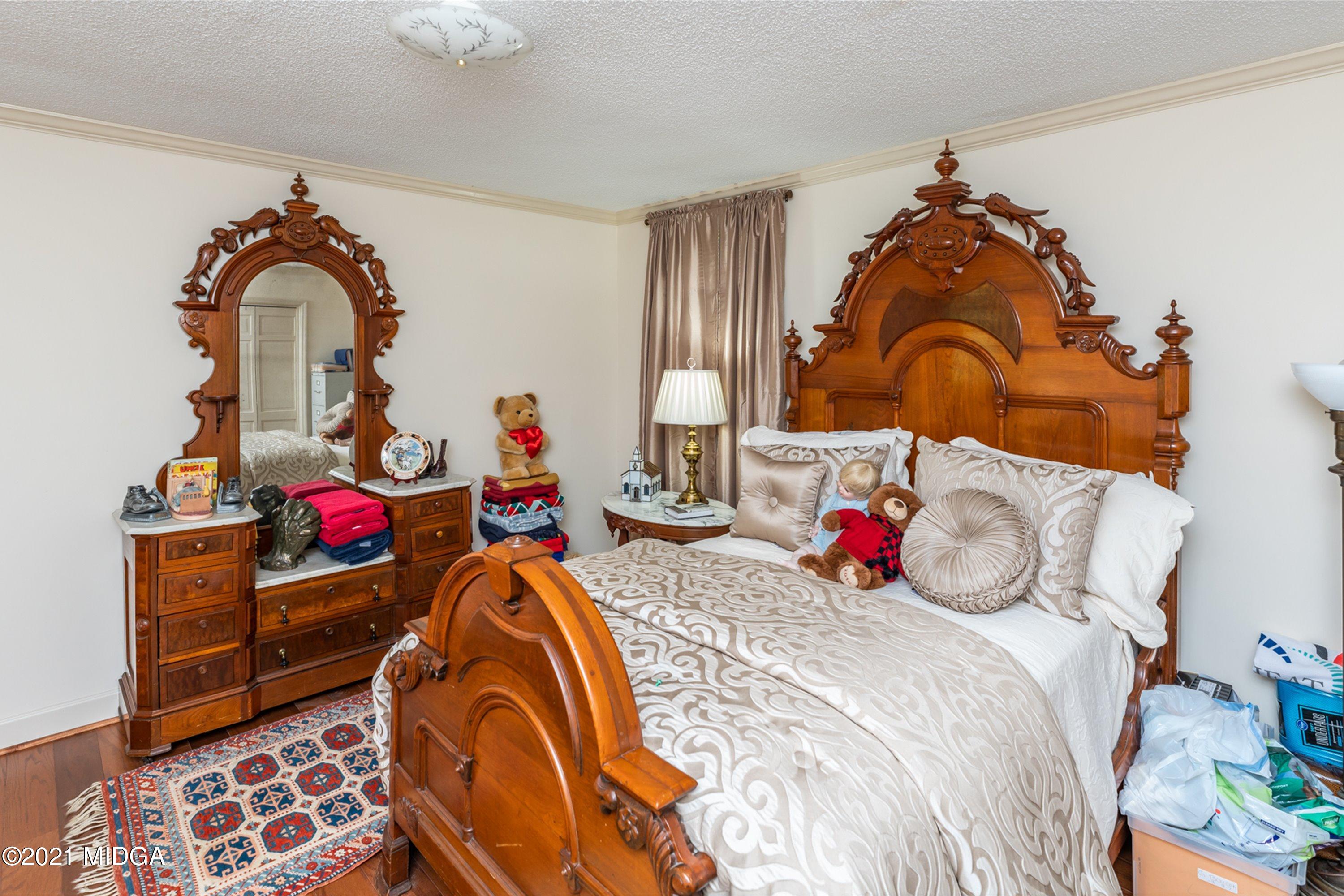 1946 Wood Valley Road Macon, GA 31211 - Photo 27 of 35 a bedroom with bed and a chandelier