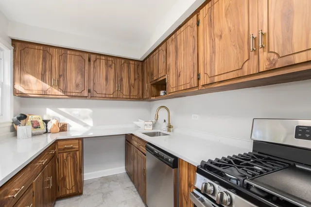 a kitchen with stainless steel appliances granite countertop a sink stove and cabinets