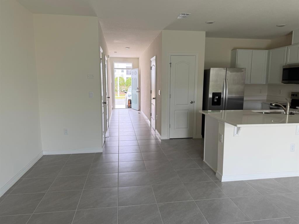 2195 Longleaf Road Davenport, FL 33837 - Photo 2 of 7 a kitchen with stainless steel appliances a refrigerator and a sink