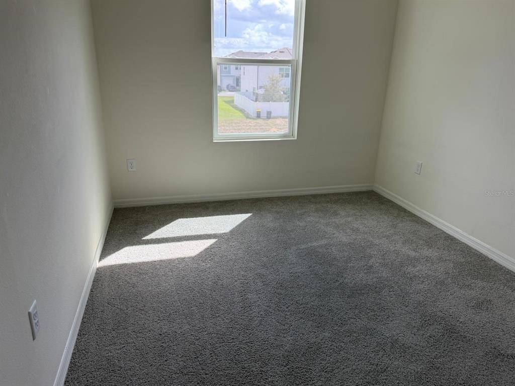 2195 Longleaf Road Davenport, FL 33837 - Photo 6 of 7 an empty room with a window