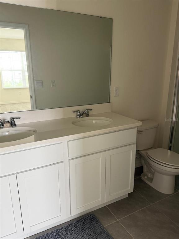 2195 Longleaf Road Davenport, FL 33837 - Photo 7 of 7 a bathroom with a sink toilet and a mirror