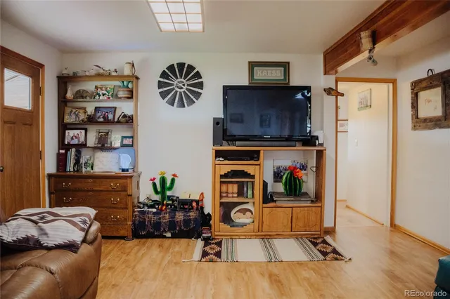 a living room with furniture cabinets and window