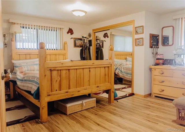 a view of a bedroom with furniture and workspace