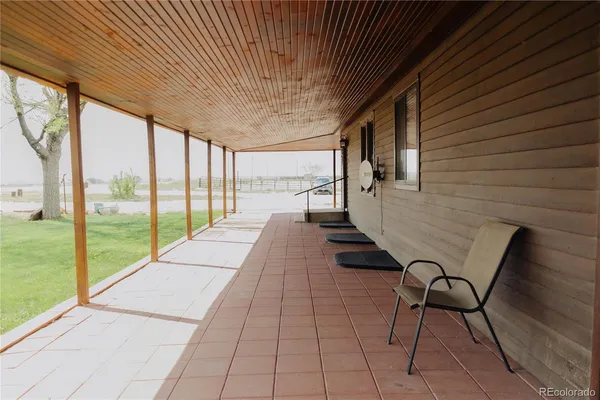 a view of a room with wooden floor and outdoor seating